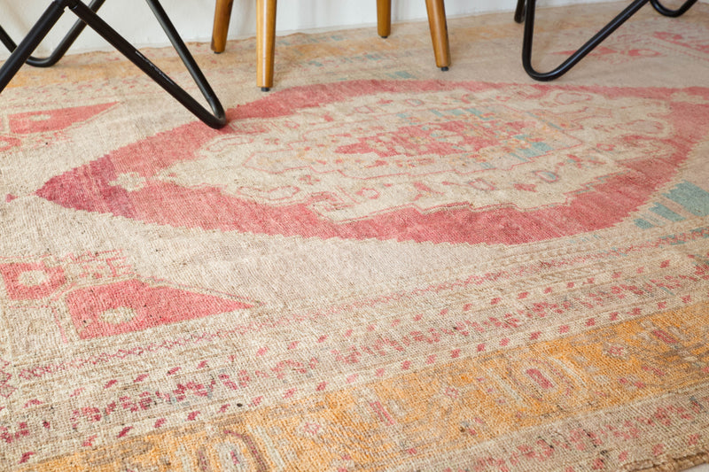 Area rug in a living room setting, pile rug, Turkish rug, old rug, antique rug, pastel colors, faded colors, Turkish rug, vintage rug, soft rug, Portland, Oregon, rug store, rug shop, local shop, distressed rug, worn out rug