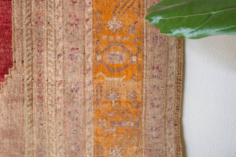 Area rug in a living room setting, pile rug, Turkish rug, old rug, antique rug, pastel colors, faded colors, Turkish rug, vintage rug, soft rug, Portland, Oregon, rug store, rug shop, local shop, distressed rug, worn out rug