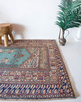Small area rug in a living room setting, pile rug, Turkish rug, old rug, antique rug, pastel colors, faded colors, Turkish rug, vintage rug, soft rug, Portland, Oregon, rug store, rug shop, local shop, cool colors
