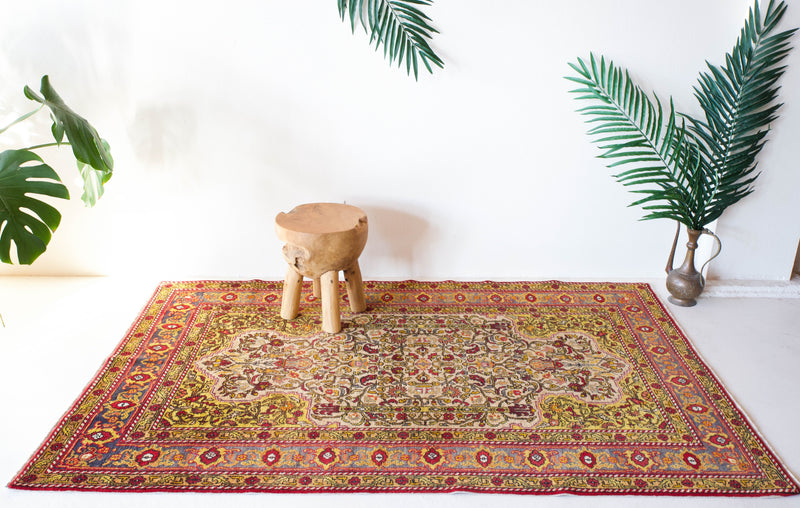 Vintage Turkish rug in a living room setting, pile rug, Turkish rug, vintage rug, portland, rug shop, bright colors, wild shaman, soft rug, bold color, Portland, Oregon, rug store, rug shop, local shop, antique rug, floral rug