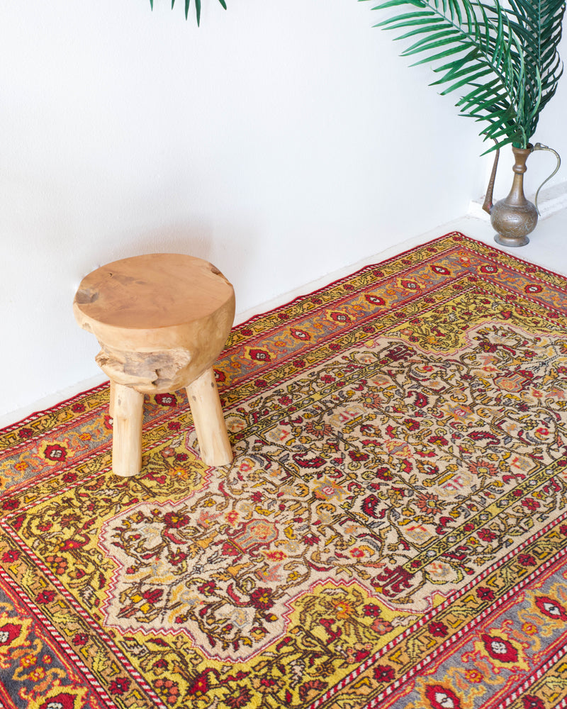 Vintage Turkish rug in a living room setting, pile rug, Turkish rug, vintage rug, portland, rug shop, bright colors, wild shaman, soft rug, bold color, Portland, Oregon, rug store, rug shop, local shop, antique rug, floral rug