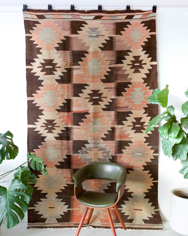 Vintage kilim rug in living room setting, old rug, antique rug, pastel colors, faded colors, Turkish rug, vintage rug, soft rug, Portland, Oregon, rug store, rug shop, local shop, earthy tones, earthy colors, warm colors