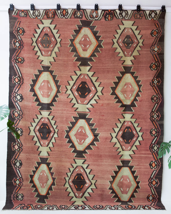 Vintage kilim rug in living room setting, old rug, antique rug, pastel colors, faded colors, Turkish rug, vintage rug, soft rug, Portland, Oregon, rug store, rug shop, local shop, earthy tones, earthy colors