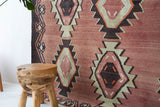 Vintage kilim rug in living room setting, old rug, antique rug, pastel colors, faded colors, Turkish rug, vintage rug, soft rug, Portland, Oregon, rug store, rug shop, local shop, earthy tones, earthy colors