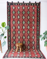 Vintage kilim rug in living room setting, old rug, antique rug, pastel colors, faded colors, Turkish rug, vintage rug, soft rug, Portland, Oregon, rug store, rug shop, local shop, earthy tones, earthy colors