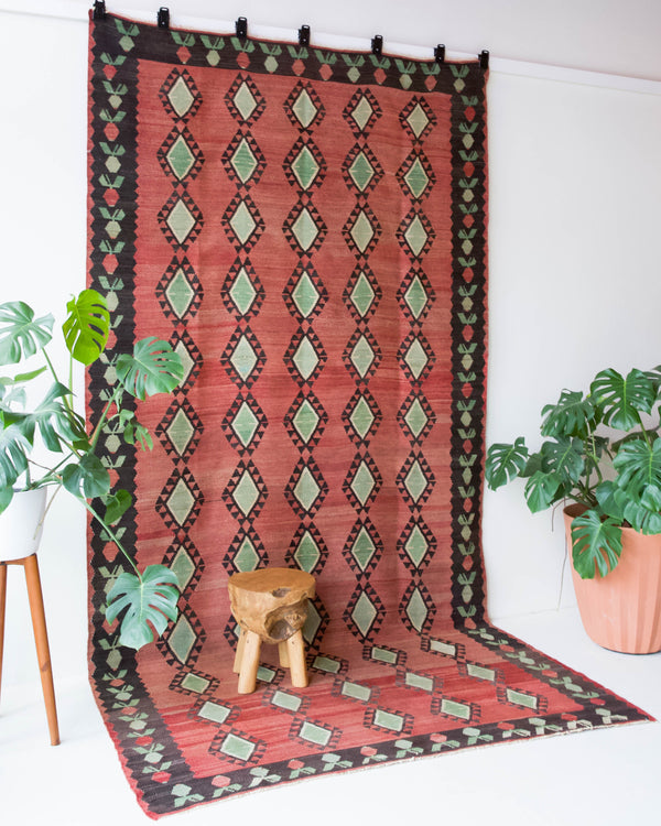 Vintage kilim rug in living room setting, old rug, antique rug, pastel colors, faded colors, Turkish rug, vintage rug, soft rug, Portland, Oregon, rug store, rug shop, local shop, earthy tones, earthy colors